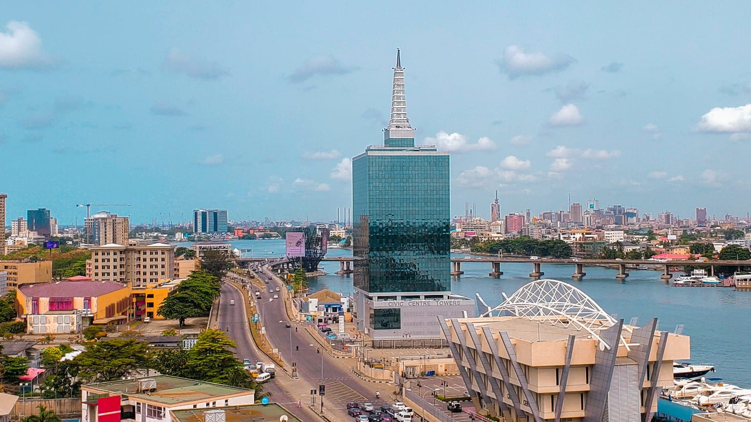 The Lagos skyline with high-rise towers beside the lagoon and bridge